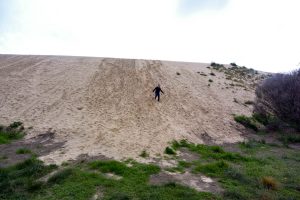 Tim Running down the sand dune at snow drift picnic area